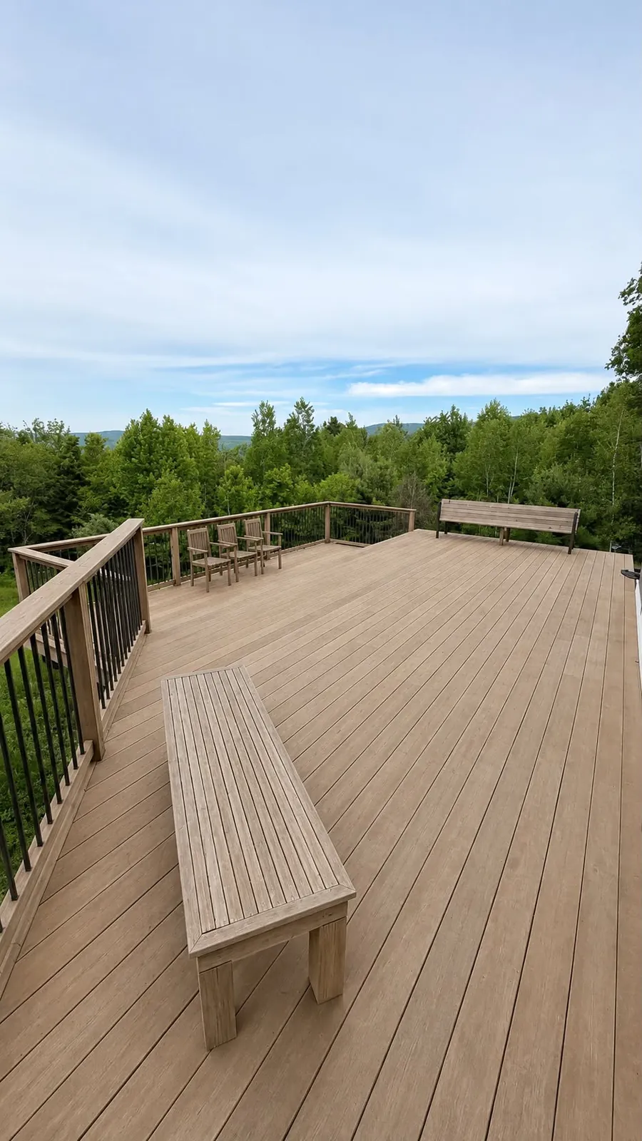 Wood deck with matching benches overlooking trees